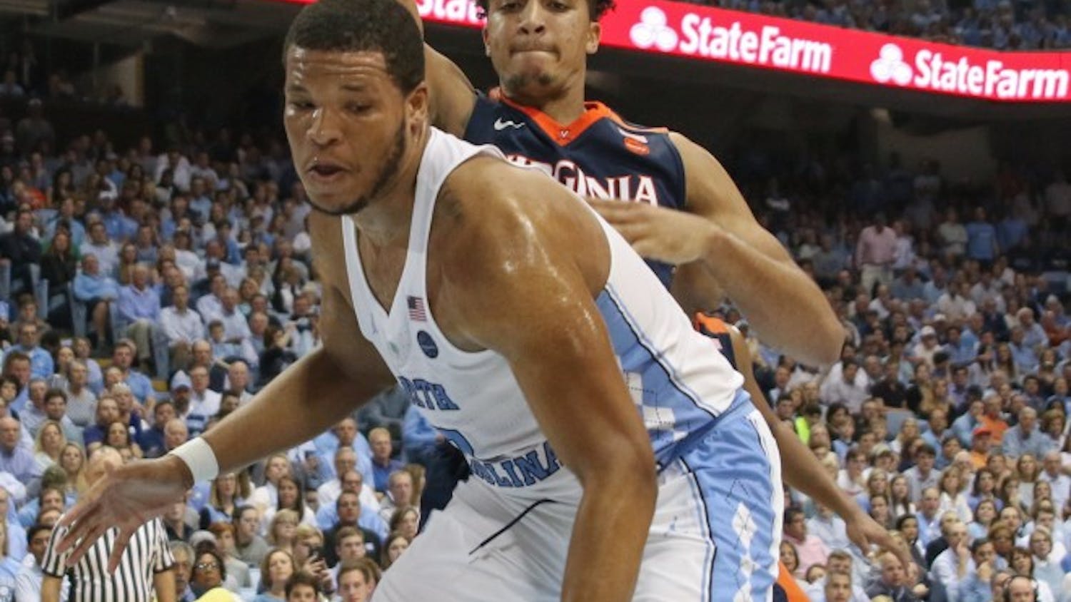 North Carolina forward Kennedy Meeks (3) attempts to work away from a Virginia defender under the basket Saturday.