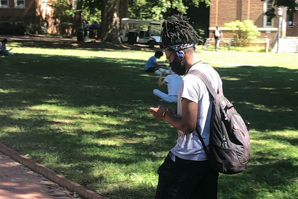 Assistant sports editor Jeremiah Holloway walks across campus in preparation for this week's Office DJ.
