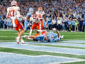 UNC redshirt first-year quarterback Drake Maye (10) slides into the endzone and scores a touchdown during the 2022 Subway ACC Football Championship Game against Clemson at the Bank of America Stadium on Saturday, Dec. 3, 2022.