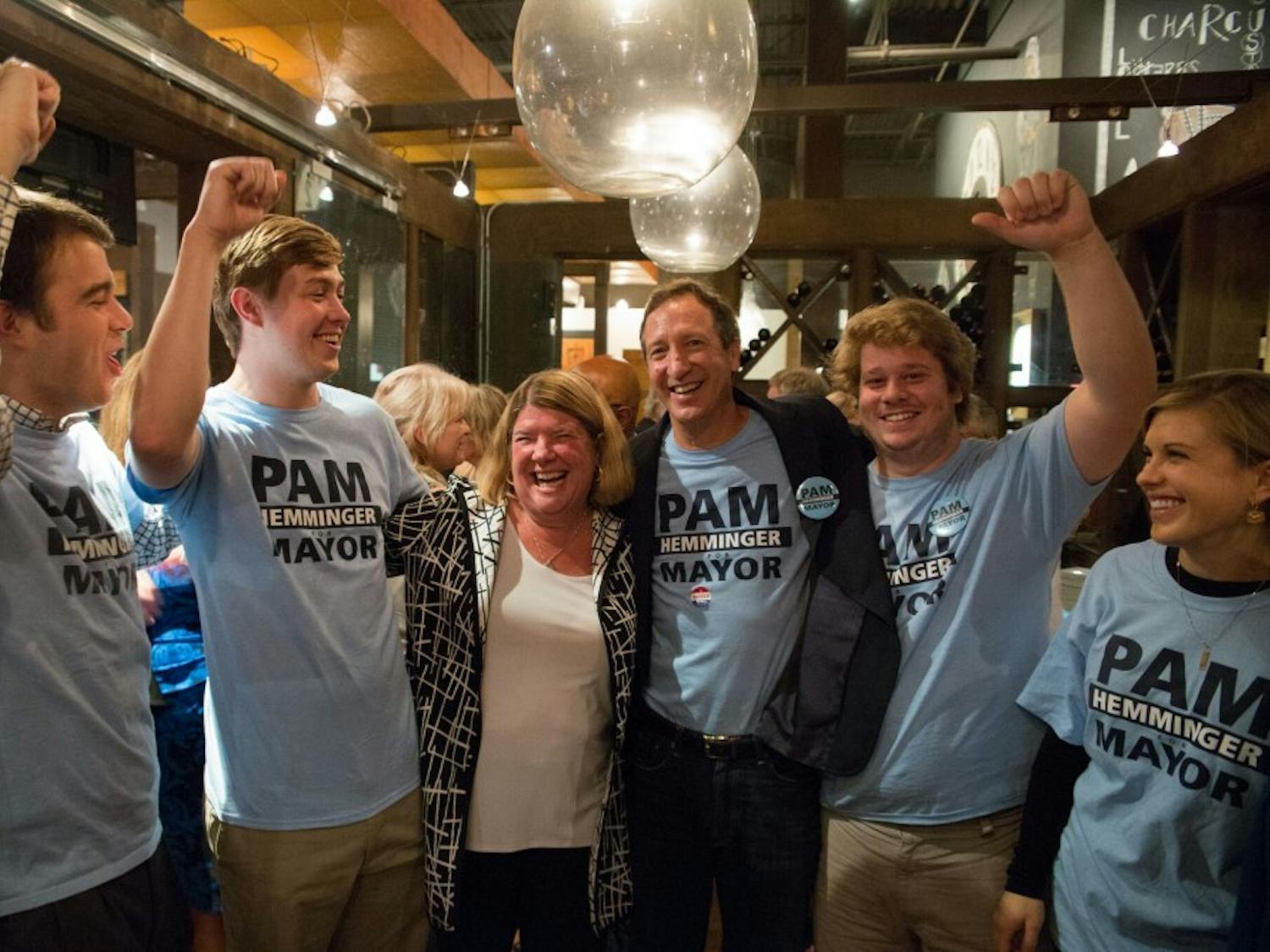 Chapel Hill Mayor Pam Hemminger (middle left) celebrates her sweeping re-election victory with her husband and children at the City Kitchen restaurant in 2017.&nbsp;