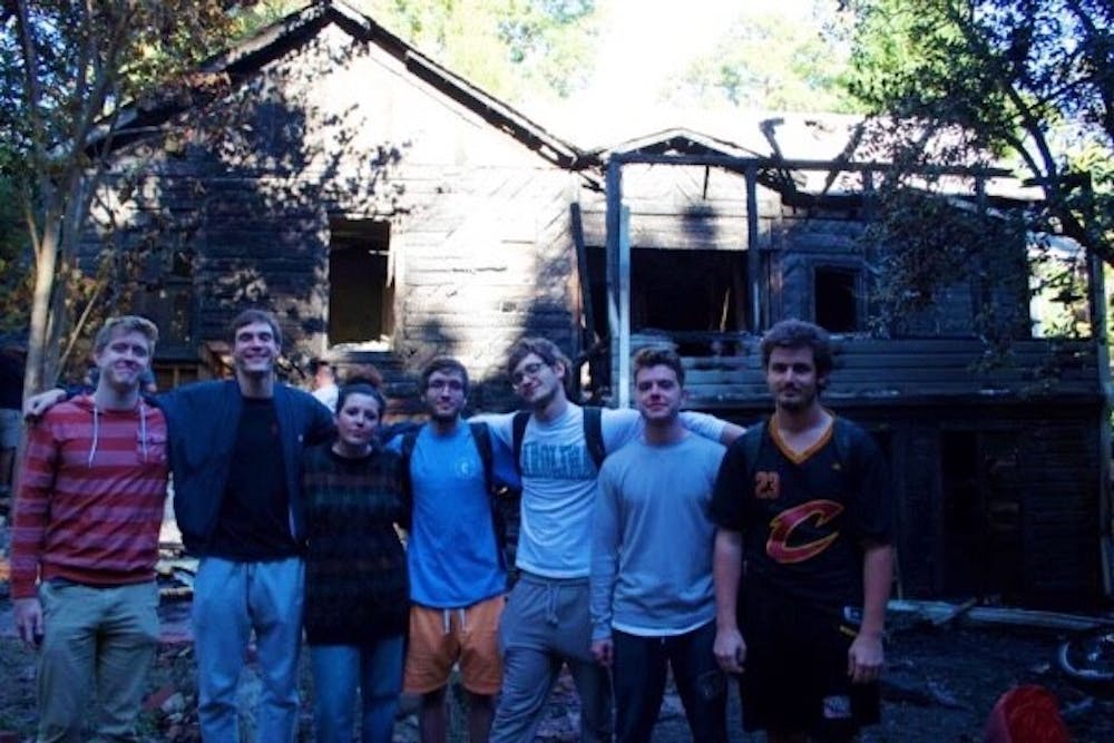 <p>Residents of 416 Pittsboro Street pose in front of their house before it burned down. Photo courtesy of Sam Gault.</p>