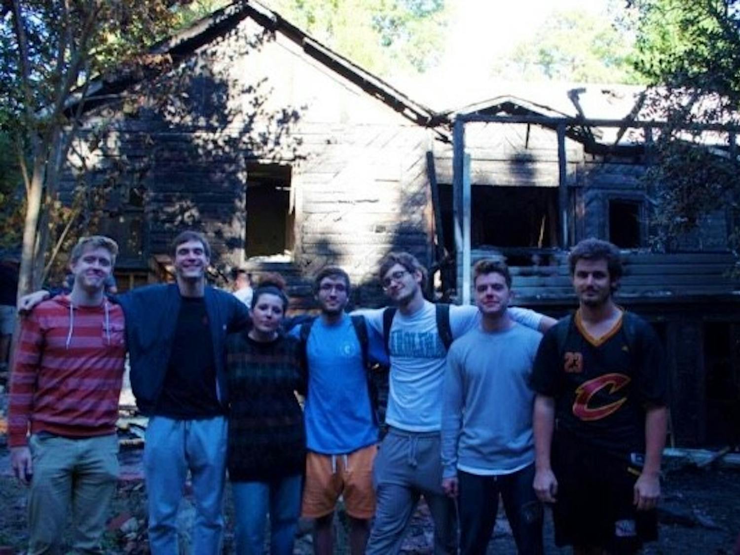 Residents of 416 Pittsboro Street pose in front of their house before it burned down. Photo courtesy of Sam Gault.