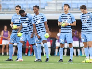 Starters on the UNC men’s soccer team line up at mid field before a home game against South Florida at Dorrance Field on Aug. 28, 2022.