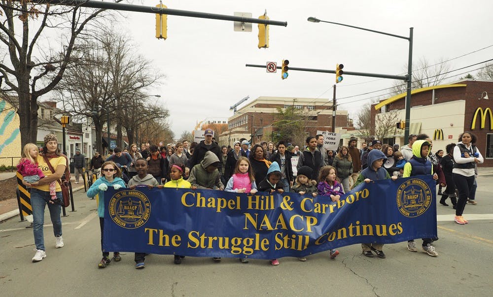 Local Chapel Hill/Carrboro youth lead the march from Peace and Justice Plaza to First Baptist Church during Monday's MLK Jr Day Celebration.