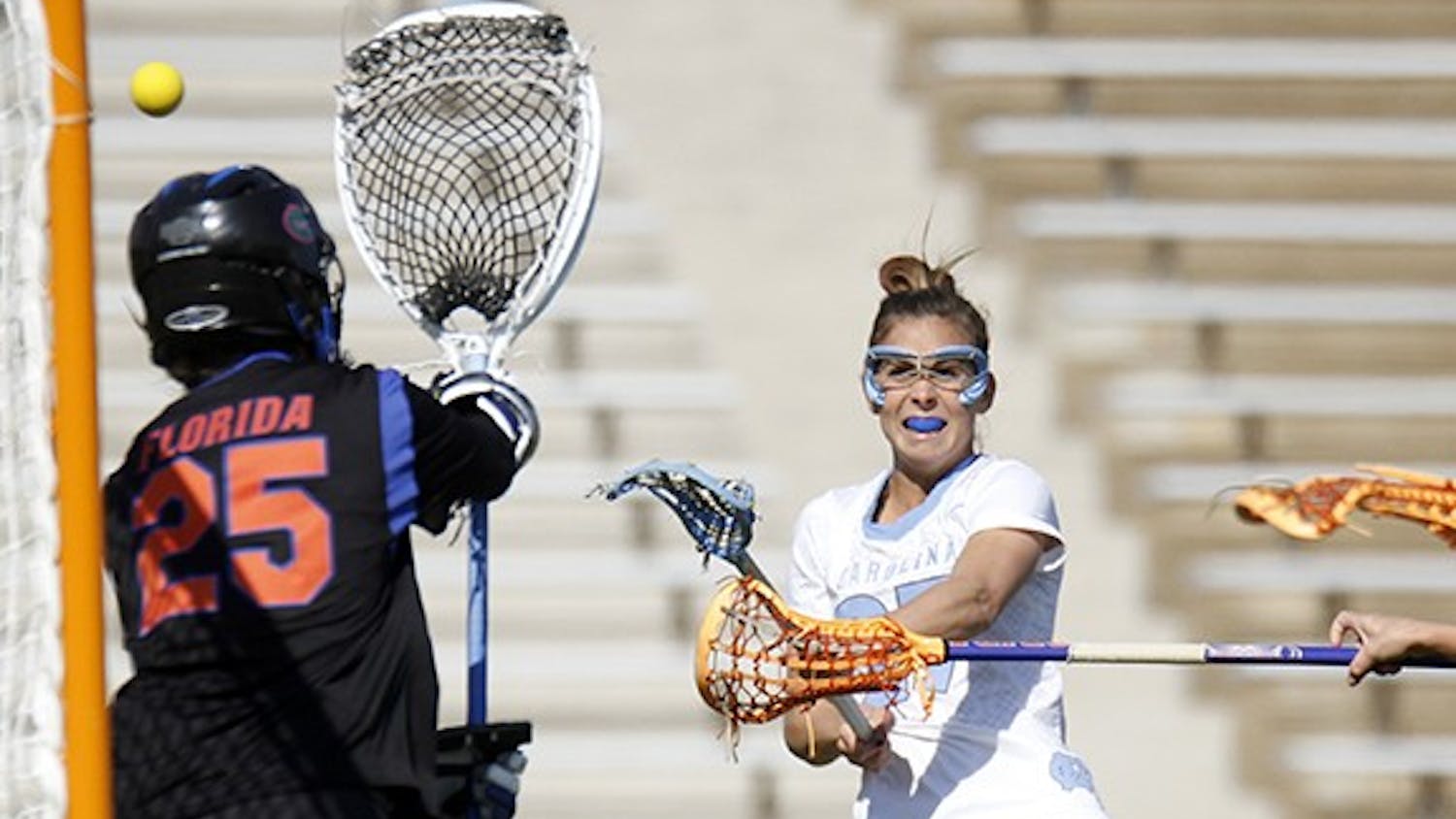 Aly Messinger (27) scores against Florida on Saturday. The Tar Heels won 20-8 at Fetzer Field. 