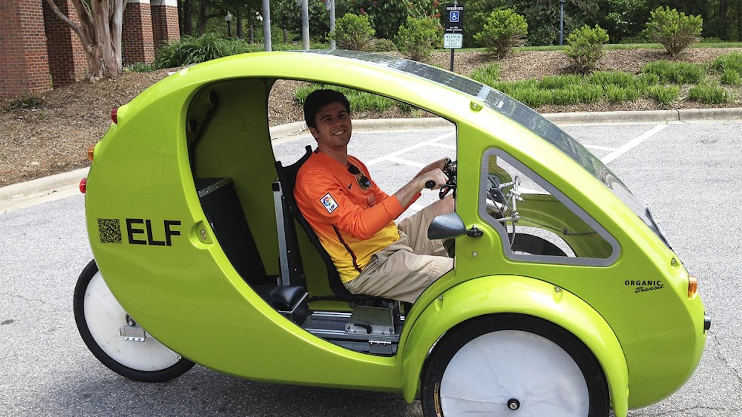 Patrick White, a senior business major, tests out an alternative form of transportation, a one-person-electrical bicycle called an ELF, in the parking lot of Kenan-Flagler on Monday afternoon.