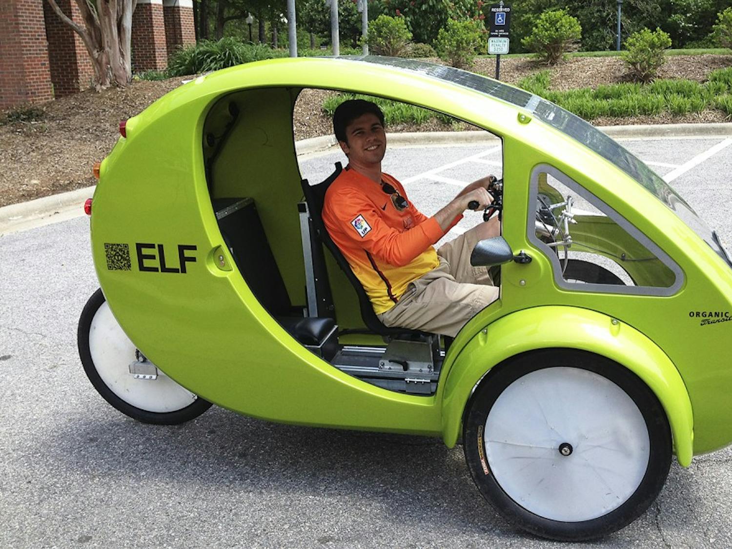 Patrick White, a senior business major, tests out an alternative form of transportation, a one-person-electrical bicycle called an ELF, in the parking lot of Kenan-Flagler on Monday afternoon.