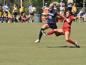 UNC Sophomore Forward Alessia Russo (19) dribbles past Freshman Louisville Defender Sarah Hernandez during Saturday's game against Louisville at WakeMed Soccer Park. UNC won 5-1
