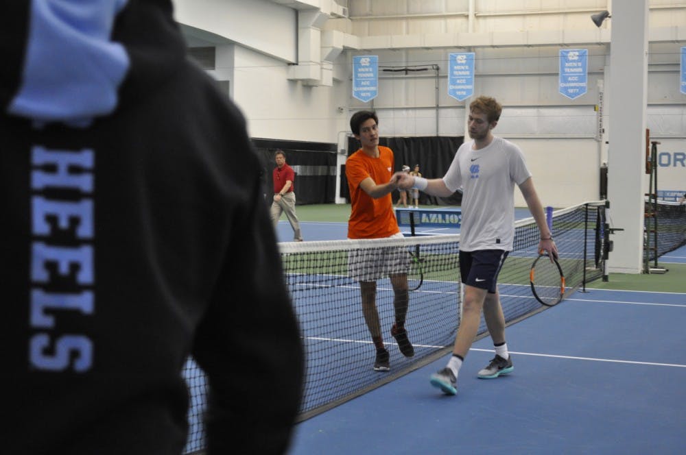 <p>Sophomore Simon Soendergaard shakes hands with his Virginia Tech opponent in the Cone-Kenfield Tennis Center on March 2.</p>