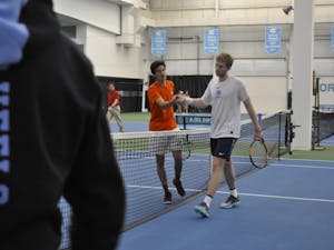Sophomore Simon Soendergaard shakes hands with his Virginia Tech opponent in the Cone-Kenfield Tennis Center on March 2.