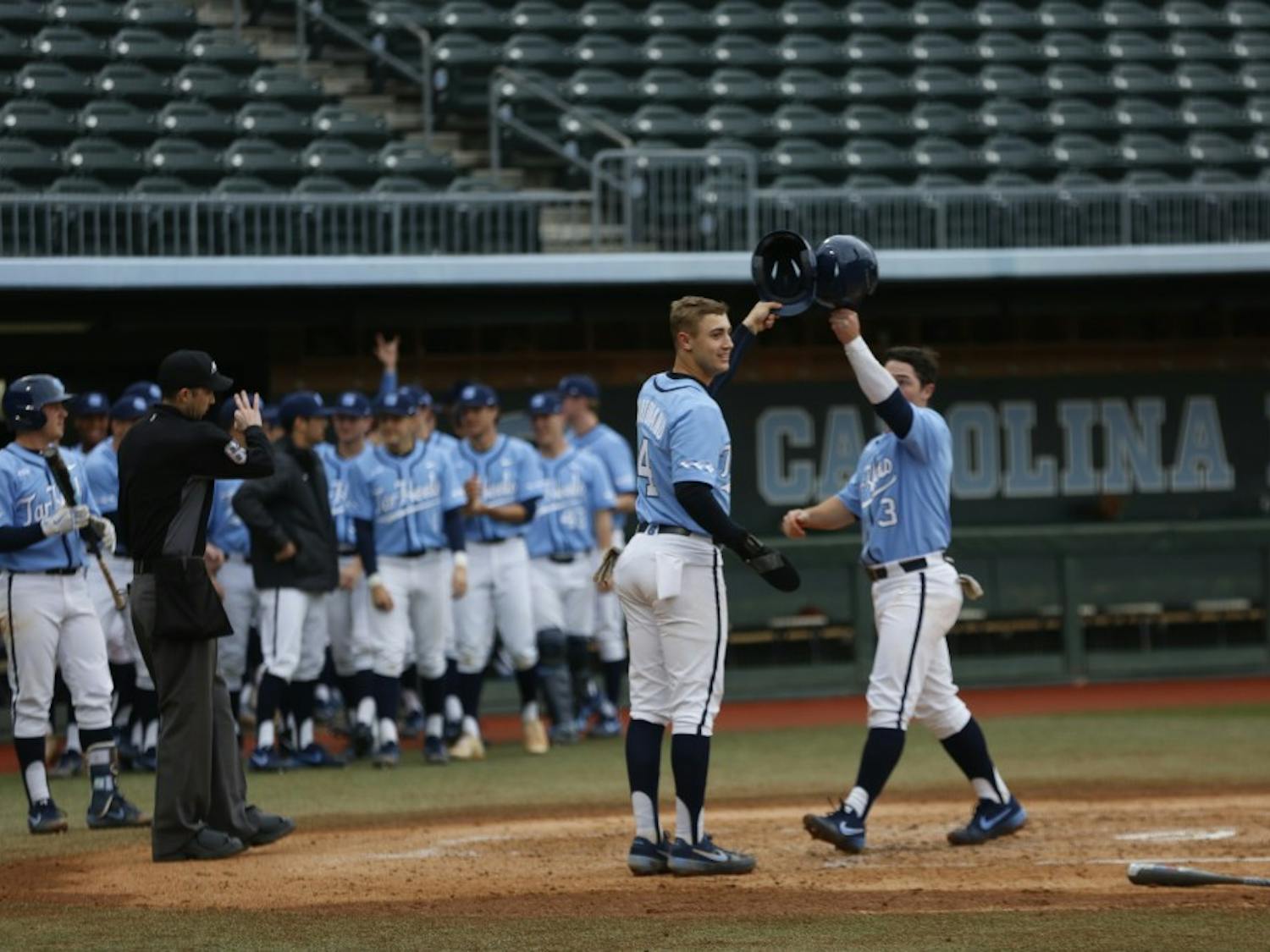 Brandon Martorano (4) and Dylan Harris (3) celebrate after a home run by Michael Busch in UNC's 11-8 loss over VCU on Wednesday, Feb. 27, 2019.