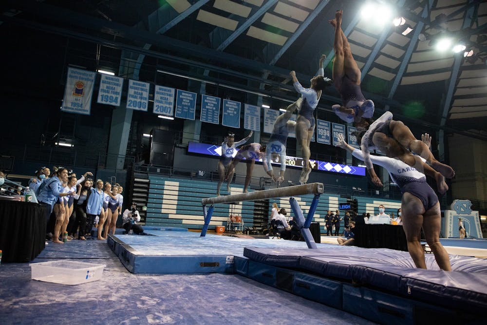 A composite image shows freshman Lali Dekanoidze dismounting from the beam during UNC's meet against West Virginia at Carmichael Arena on Feb. 24, 2022. 