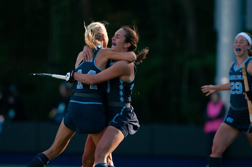 <p>Senior Marissa Creatore (33) celebrates fellow Senior Faline Guenther's (14) game-winning goal in the second overtime of Carolina's 3-2 victory of Saint Joseph's University on Sunday, Nov. 3, 2019. The team's 40th straight win came on the last game of the regular season, sealing their second-straight undefeated regular season.</p>