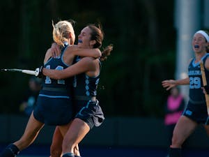 Senior Marissa Creatore (33) celebrates fellow Senior Faline Guenther's (14) game-winning goal in the second overtime of Carolina's 3-2 victory of Saint Joseph's University on Sunday, Nov. 3, 2019. The team's 40th straight win came on the last game of the regular season, sealing their second-straight undefeated regular season.