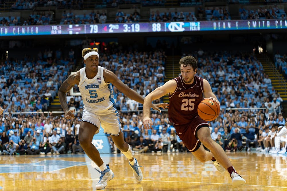 UNC senior center Armando Bacot (5) chases forward Ben Burnham (25) during the game against College of Charleston on Friday, Nov. 11, 2022, at the Dean Smith Center. UNC beat College of Charleston 102-86.
