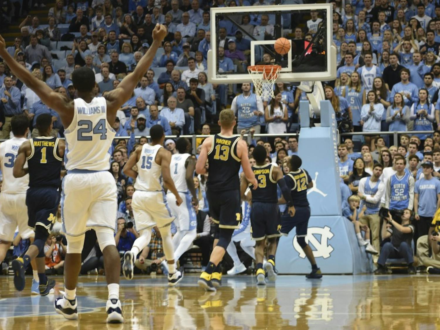 Guard Kenny Williams (24) watches a last-second first-half shot against Michigan in the Smith Center.