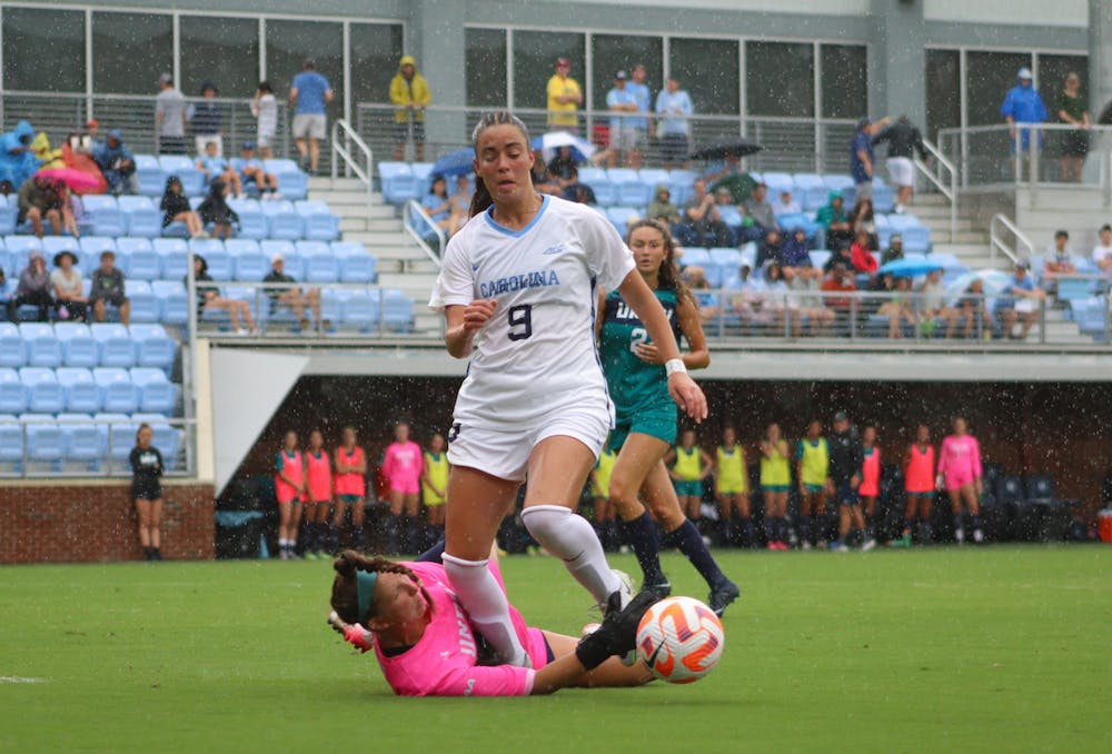 First-year forward Tori Dellaperuta (9) takes a shot on goal above the UNCW goalkeeper. UNC won 2-0 at home against UNCW on Sunday, Aug. 21, 2022.