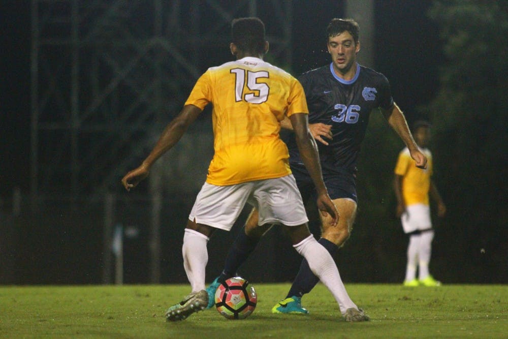 UNC forward Tucker Hume (36) dribbles past VCU defender RJ Roberts (15)&nbsp;on Monday night. Hume scored the game-winning shot in the final 10 minutes&nbsp;to lift the Tar Heels to a 3-2 victory.