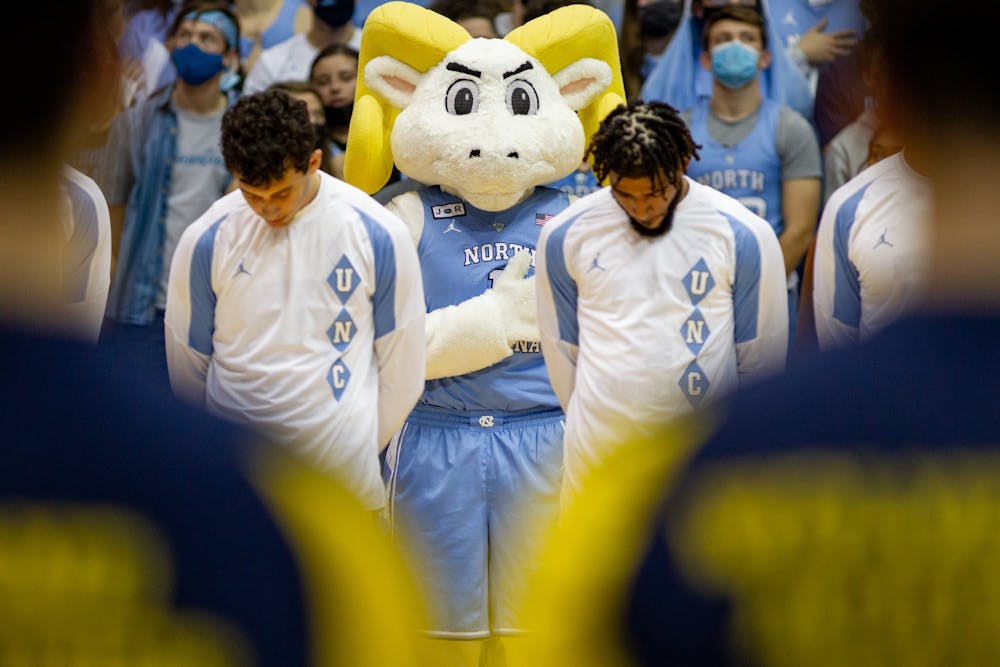 Rameses stands for the playing of the national anthem at men before UNC basketball's home game against Michigan on Wednesday, Dec. 1, 2021. UNC won 72-51.