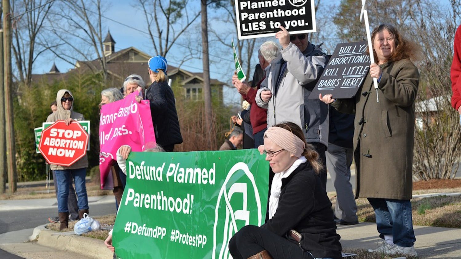 People protest against abortion and Planned Parenthood outside the Planned Parenthood building on Dobbins Drive on February 11, 2017.