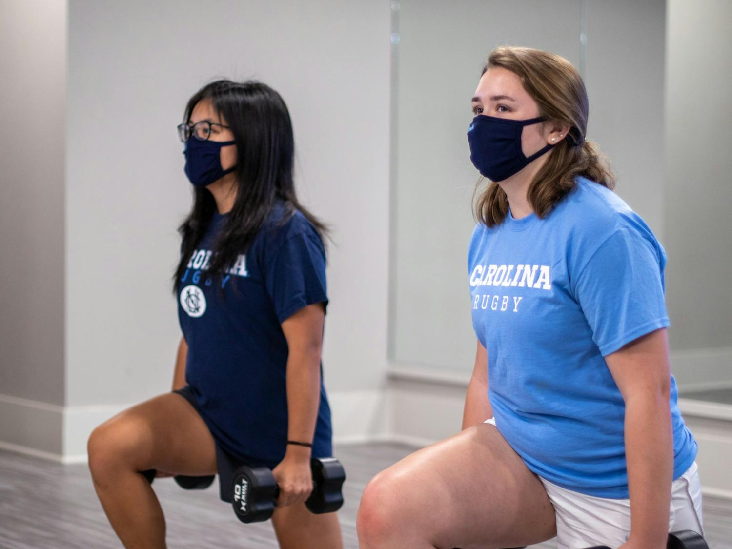 Sophomore policitcal science and environmental studies major Rebecca Lee works out with senior Amy Chau, president of the women's rugby team. The team has continued to work out on their own in small groups to continue community-building and spending time together during the pnandemic.