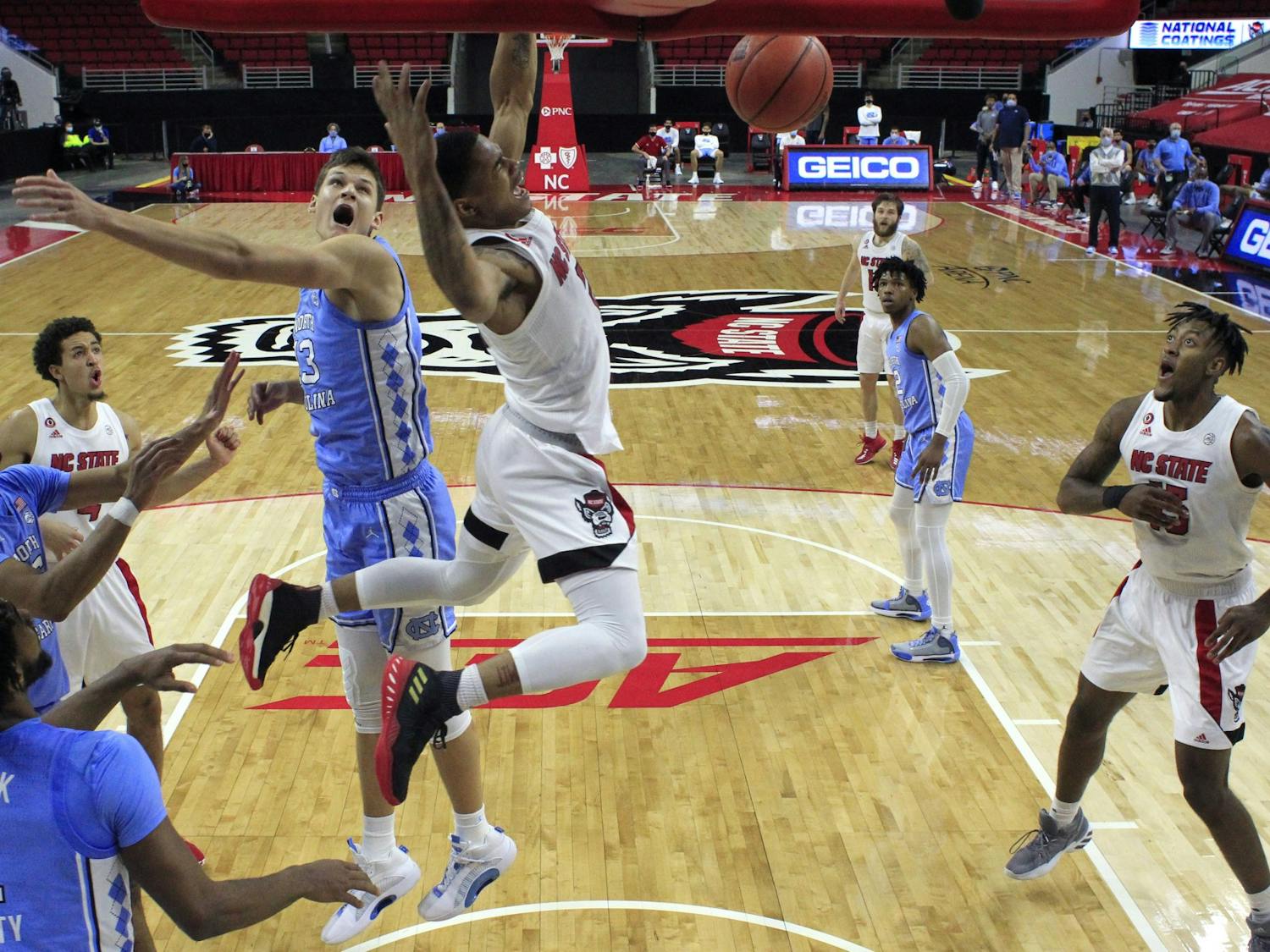 N.C. State's Shakeel Moore (2) slams in two in the second half during N.C. State’s 79-76 victory over UNC at PNC Arena in Raleigh, N.C., Tuesday, December 22, 2020. Photo courtesy of Ethan Hyman. 