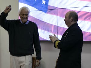 Retired US Marine Corps Captain Larry Greenwold accepts a token from Captain Marc Stern at the annual Veterans' Day Ceremony hosted by UNC RTOC at the UNC NROTC Naval Armory Monday, Nov. 12, 2018.