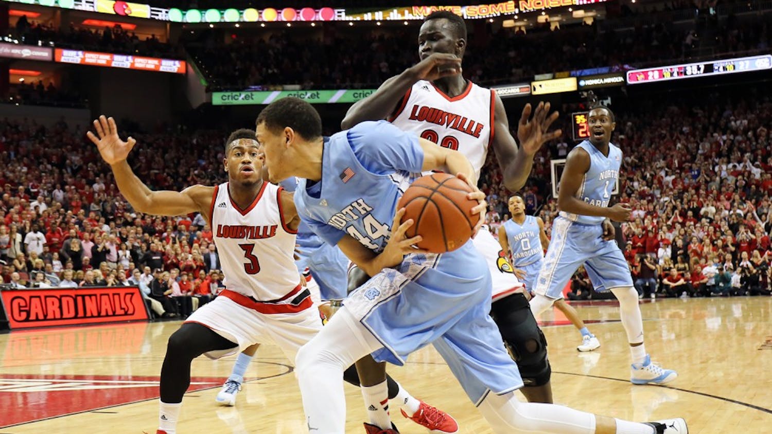 Justin Jackson (44) drives past Louisville defenders during Monday night's loss.