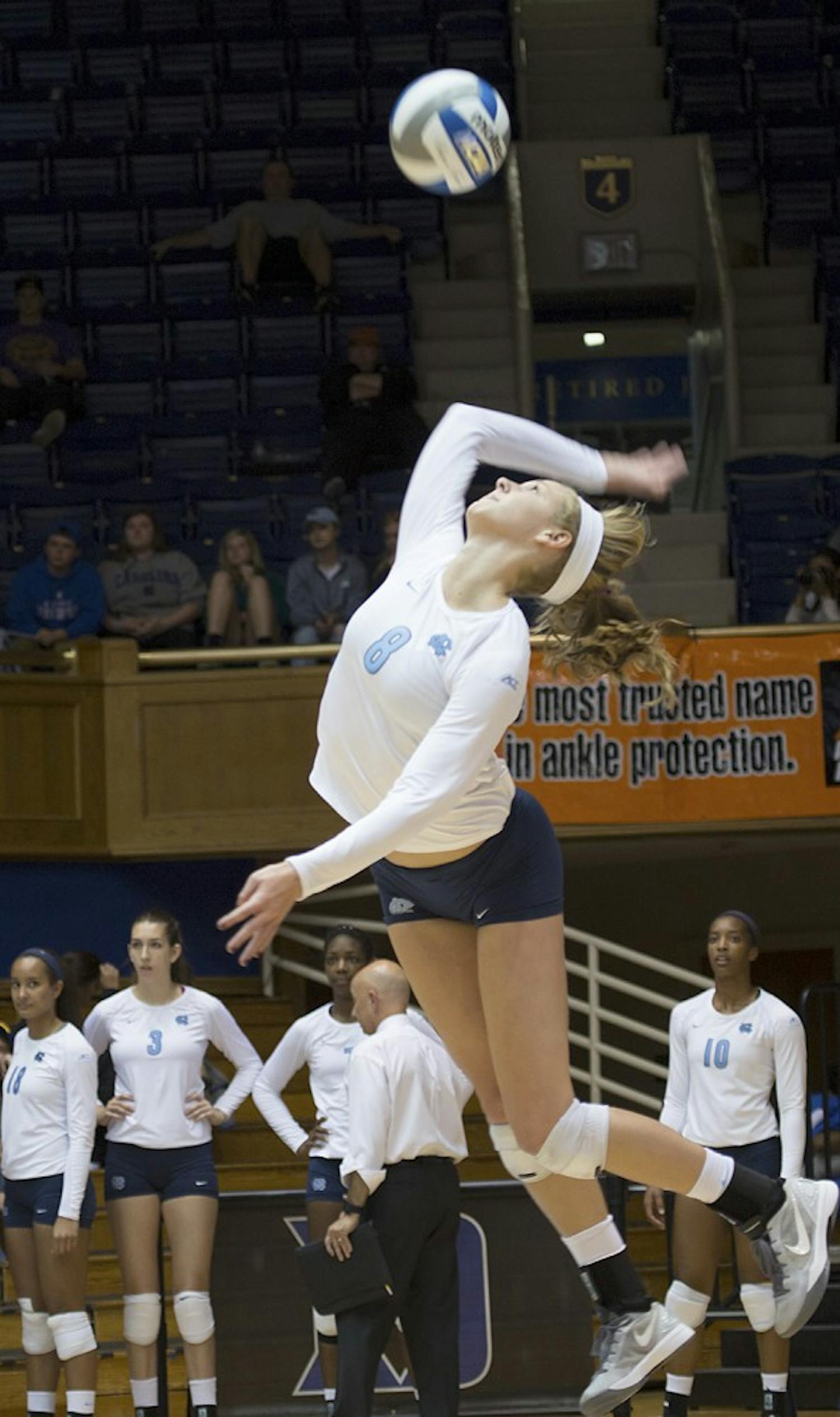 UNC outside hitter Lauren McAdoo (8) serves the ball during Sunday's 3-0 win against Duke at Cameron Indoor Stadium.