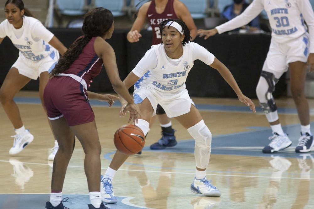First-year guard Kennedy Todd-Williams (3) drives the ball upcourt against South Carolina State in Carmichael Arena on Dec. 3, 2020. UNC beat SC State 98-28.