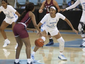 First-year guard Kennedy Todd-Williams (3) drives the ball upcourt against South Carolina State in Carmichael Arena on Dec. 3, 2020. UNC beat SC State 98-28.