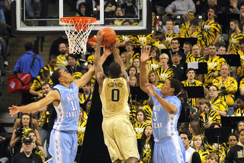 <p>UNC forward Brice Johnson (11) blocks a shot by Wake Forest guard Codi Miller-McIntyre (0). Wake defeated UNC 73-67 on Jan. 5 at the LJVM Coliseum in Winston-Salem. They will meet again Jan. 21.</p>