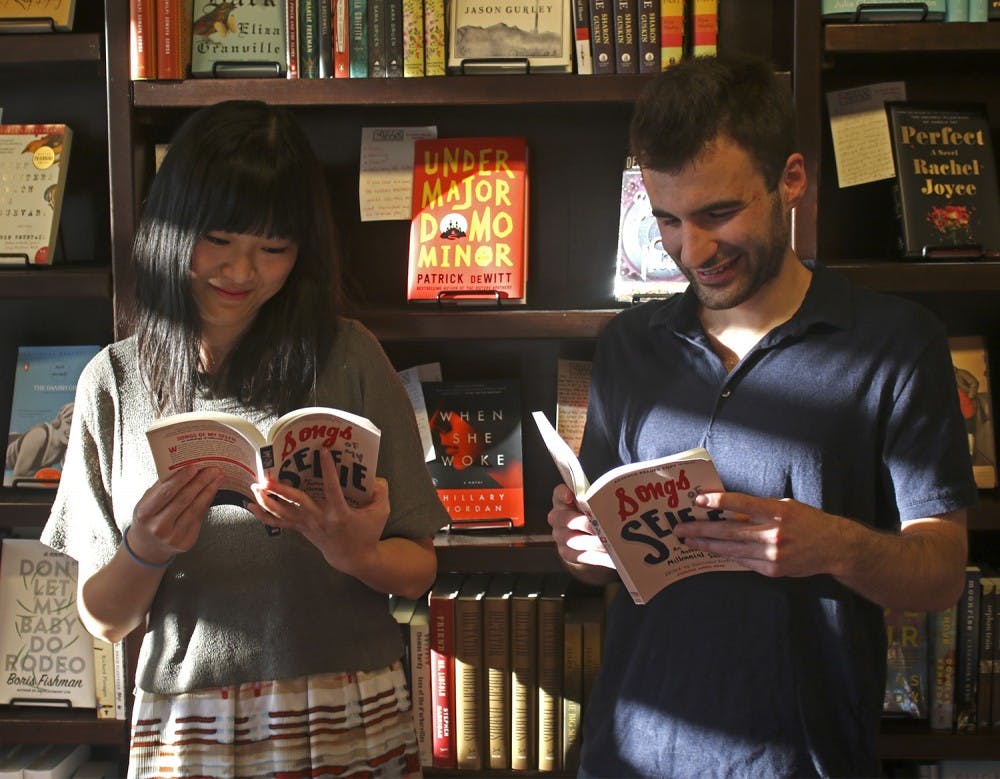 UNC senior Sarah He (left) and graduate Jared Shaffer read the book they both contributed chapters too, "Song of my Selfie". They both spoke at FlyLeafs Books bookstore in Chapel Hill on Monday.