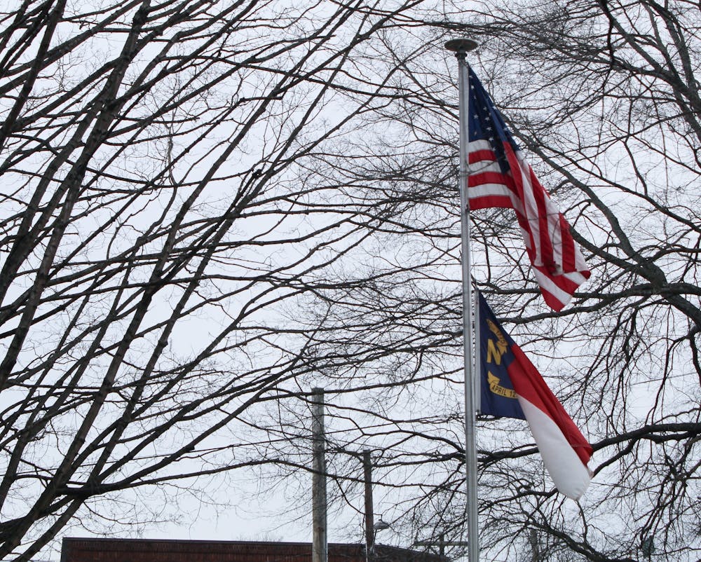 <p>The national and state flag stand outside of the Board of Elections building in Hillsborough, N.C. on Feb. 8, 2020.&nbsp;</p>
