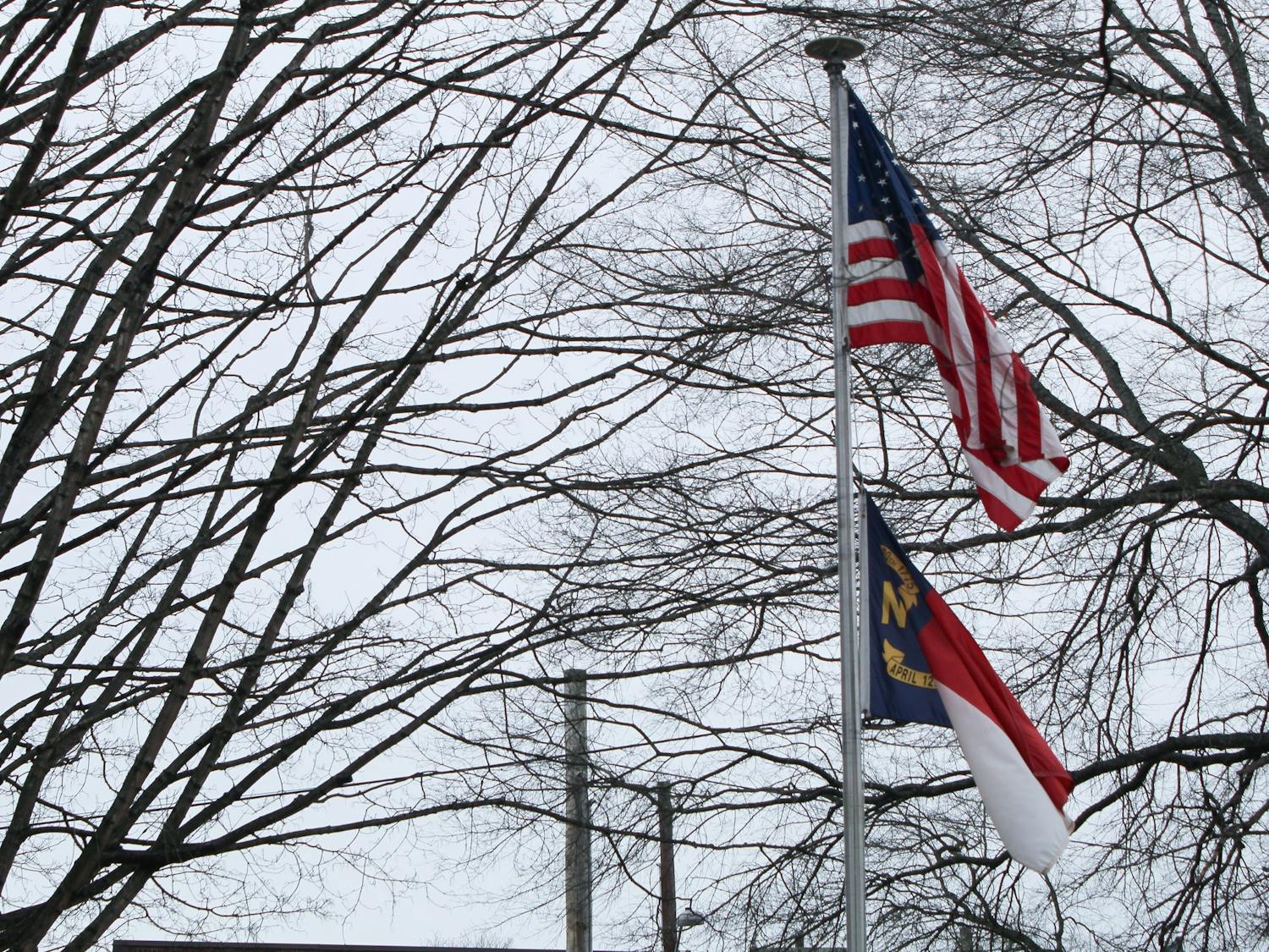 The national and state flag stand outside of the Board of Elections building in Hillsborough, N.C. on Feb. 8, 2020.&nbsp;