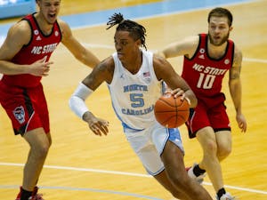 UNC sophomore forward Armando Bacot (5) drives to the basket in the Smith Center during a game against NC State on Saturday, Jan. 23 2021. UNC beat NC State 86-76.