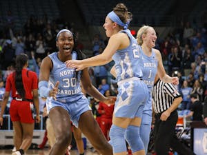 UNC players Janelle Bailey (30), Leah Church (20), and Taylor Koenen (1) celebrate UNC's win over N.C. State on Thursday, Jan. 9, 2020. UNC broke NC State's undefeated streak with a score of &nbsp;66-60.