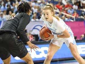 UNC sophomore guard Alyssa Ustby (1) squares off with a Hokie during the quarterfinals of the ACC Women's Basketball Tournament against Virginia Tech at the Greensboro Coliseum. Virginia Tech won 87-80 in overtime.