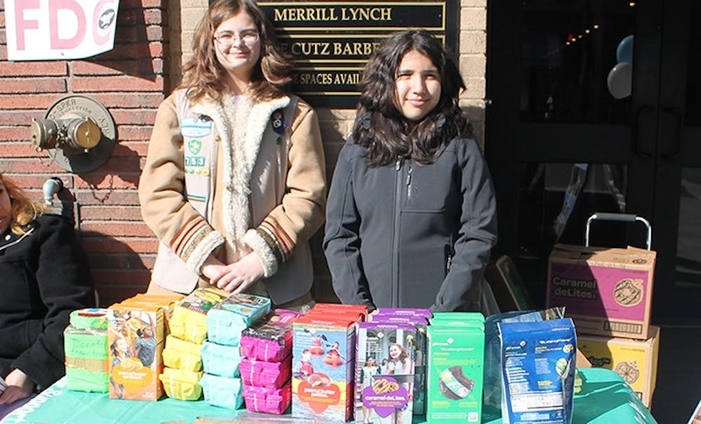 	Katie Sanfilippo, 12, and Maria Jose, 13, from Troop 753 sell Girl Scout cookies on Franklin Street on Sunday.