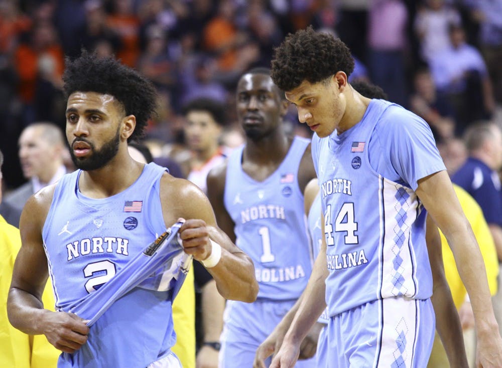 North Carolina guard Joel Berry (2) and wings Justin Jackson (44) and Theo Pinson (1) walk back to the locker room after losing to Virginia on the road on February 27th.