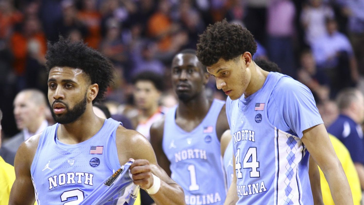 North Carolina guard Joel Berry (2) and wings Justin Jackson (44) and Theo Pinson (1) walk back to the locker room after losing to Virginia on the road on February 27th.