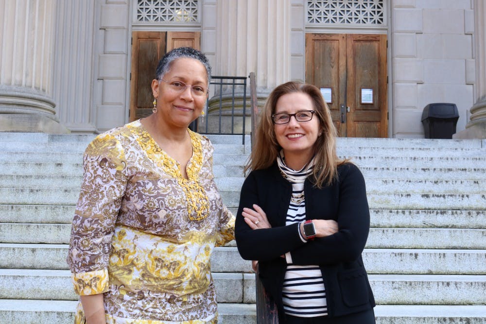 Gloria Thomas (left), partner and Director of the Carolina Women's Center, and Erin Malloy (right), lead principal investigator of the National Science Foundation grant pose in front of Wilson Library on Tuesday, Jan. 8, 2019. The grant is aimed to encourage women and women of color to succeed in STEM fields. 