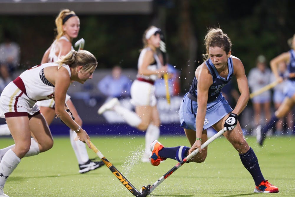 <p>UNC senior midfielder Yentl Leemans (18) takes control of the ball from a Boston College player during a game in Karen Shelton Stadium on Friday, Oct. 25, 2019. The Tar Heels beat Boston College 3-2.</p>