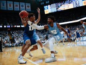 UNC sophomore Leaky Black attempts to steal the ball from a Duke player during the rivalry game in the Smith Center on Saturday, Feb. 8, 2020.