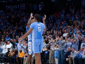 UNC graduate forward Leaky Black (1) and senior forward/center Armando Bacot (5) high-five to celebrate the end of the men's basketball game against Michigan at the Jumpman Invitational in Charlotte, N.C., on Wednesday, Dec. 21, 2022. UNC beat Michigan 80-76.