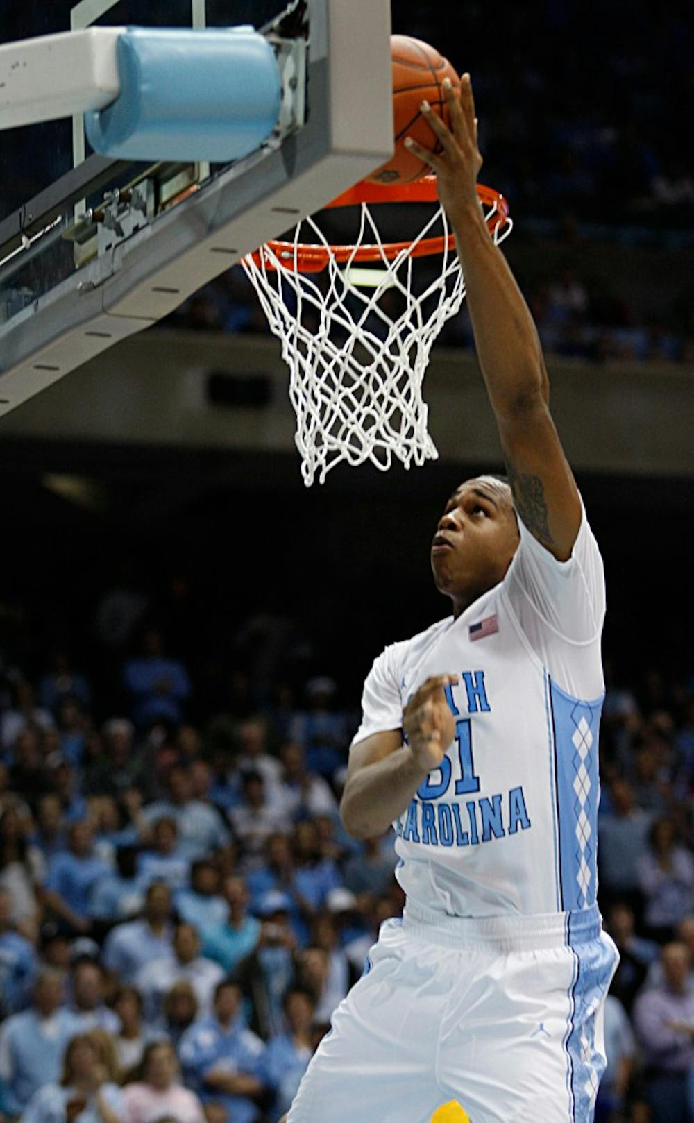 North Carolina forward John Henson lays the ball into the basket during the game against the Long Beach State at the Dean E. Smith Center on Saturday. 