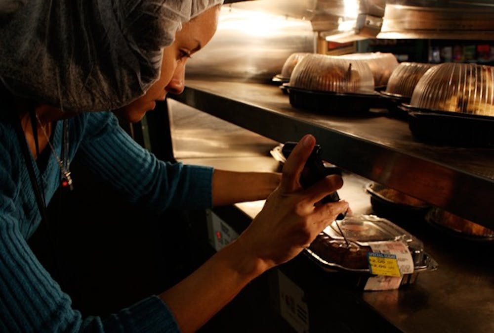 Environmental health specialist Shaquetta Cooper checks the temperature of chicken at a local grocery store deli. DTH/Daixi Xu