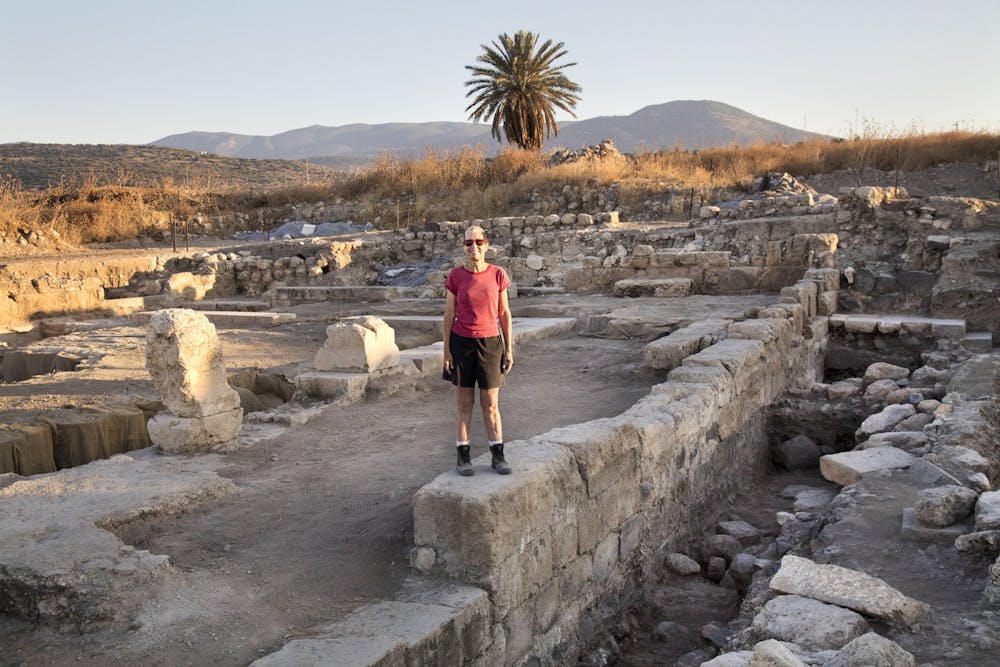 <p>Professor Jodi Magness stands on the east wall of a Jewish synagogue in Israel's Lower Galilee, which Magness and their team have been working to excavate. Magness and their team have discovered depictions of Deborah and Jael, who are known biblical heroes. <br>
Photo Courtesy of Jim Haberman.</p>
