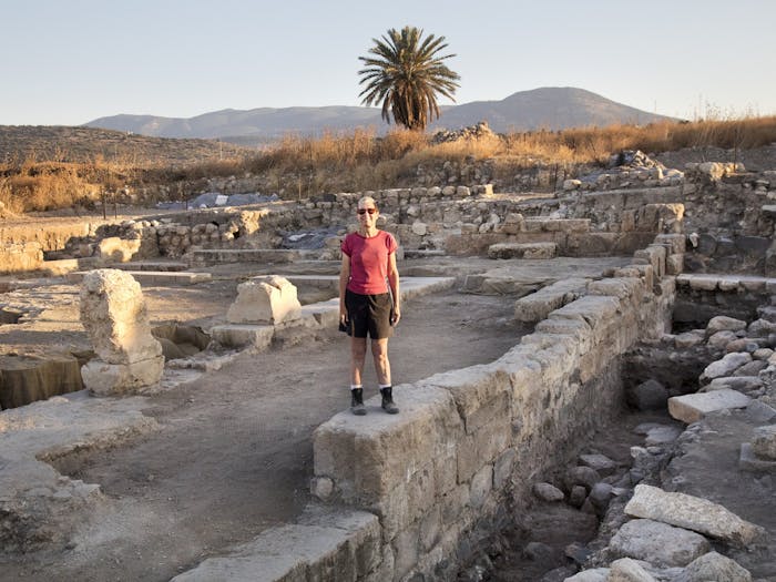 Professor Jodi Magness stands on the east wall of a Jewish synagogue in Israel's Lower Galilee, which Magness and their team have been working to excavate. Magness and their team have discovered depictions of Deborah and Jael, who are known biblical heroes. 
Photo Courtesy of Jim Haberman.