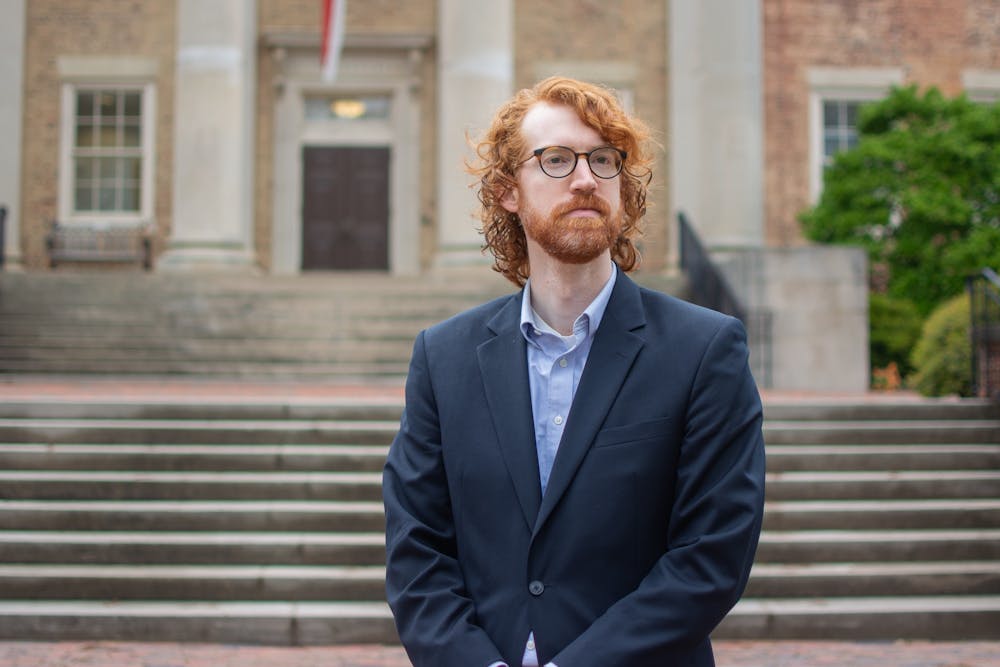 <p>Theodore Nollert, the former Graduate and Professional Student Body President, poses outside of South Building on Monday, March 27, 2023.&nbsp;</p>